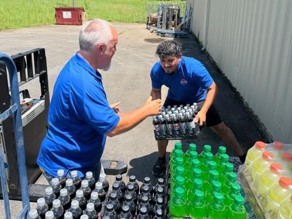 PepsiCola employees loading cases of soda